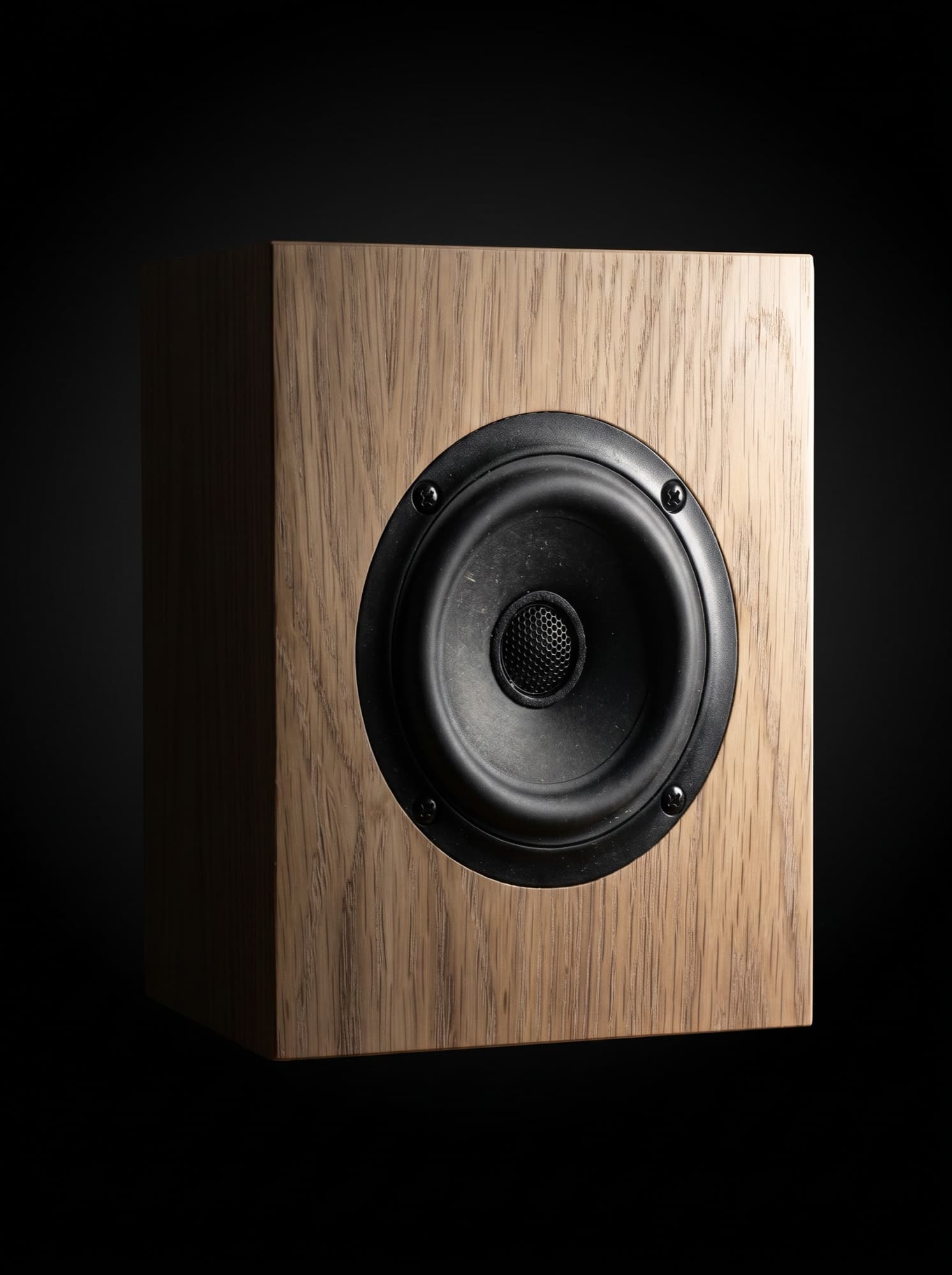 The Cube in oak, front three-quarter, dark studio